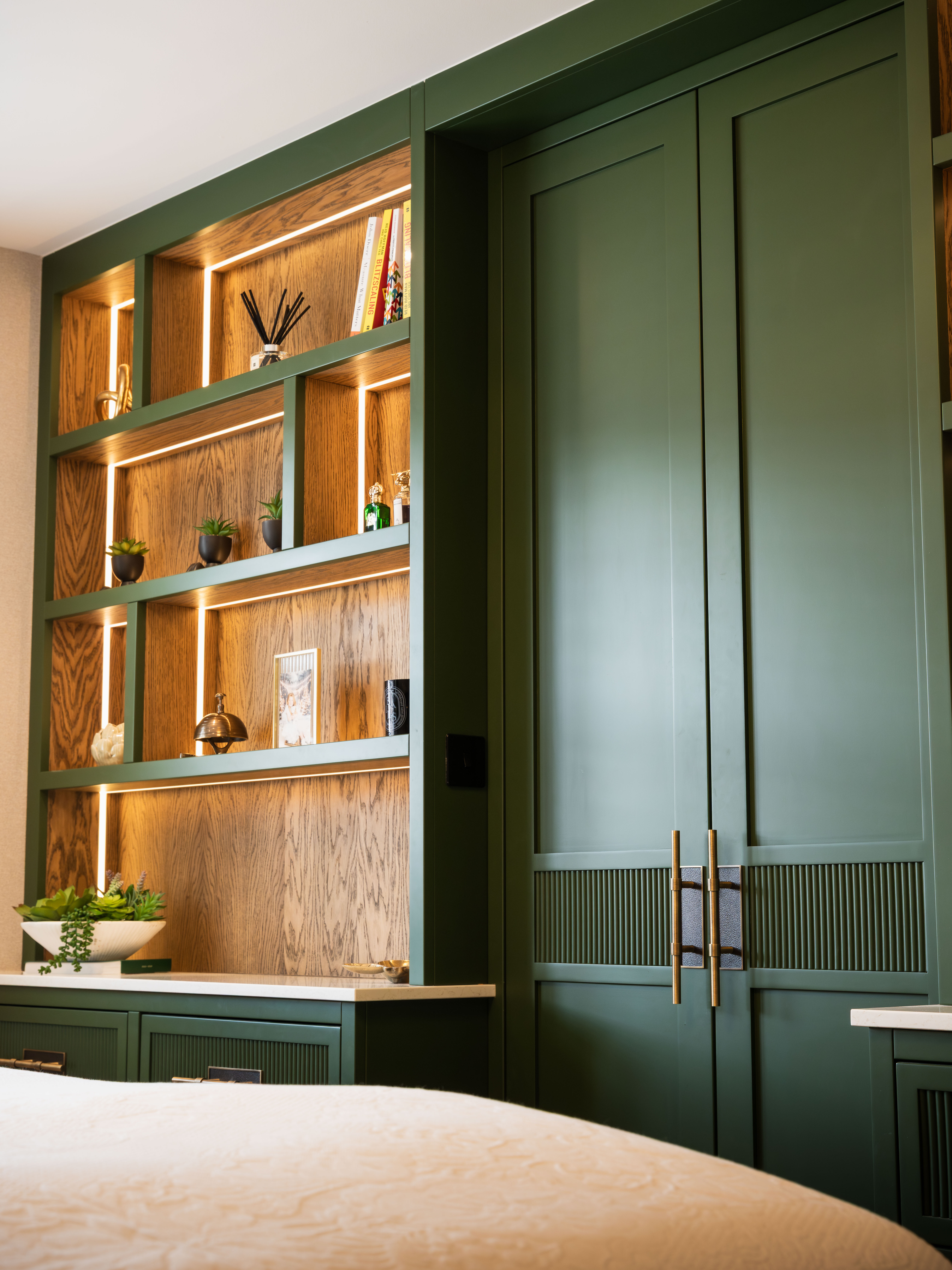 Bespoke forest green fitted bedroom with LED shelving — Hafferty Interiors Manchester
