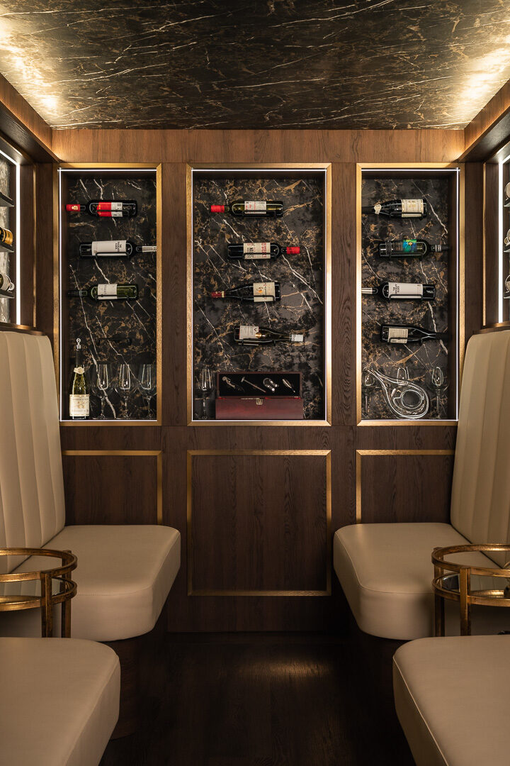 Bespoke wine cellar with full-height bottle racking and warm mood lighting — Hafferty Interiors