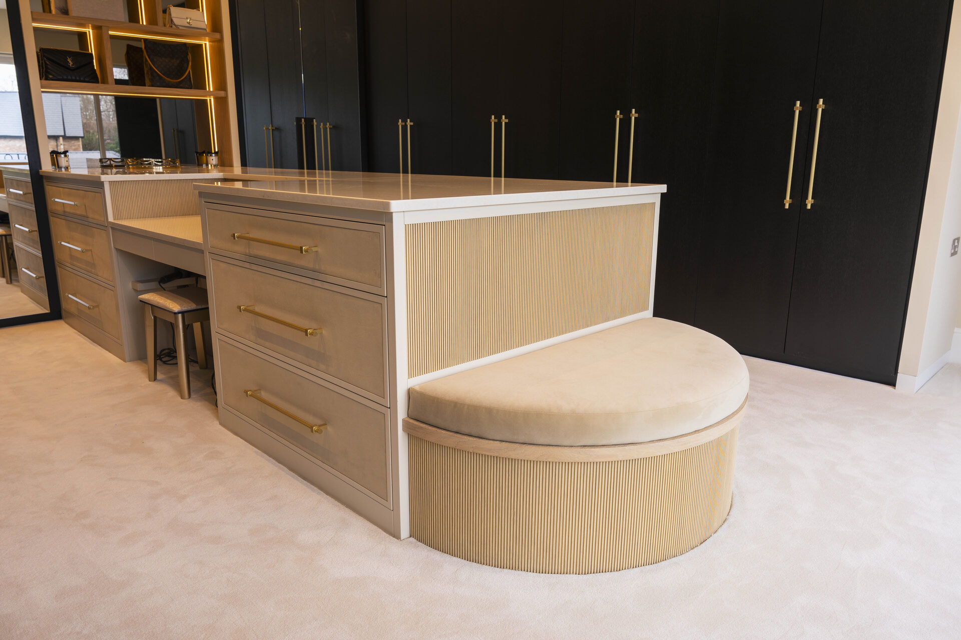 Grand bespoke walk-in wardrobe Manchester — curved fluted oak island by Hafferty Interiors